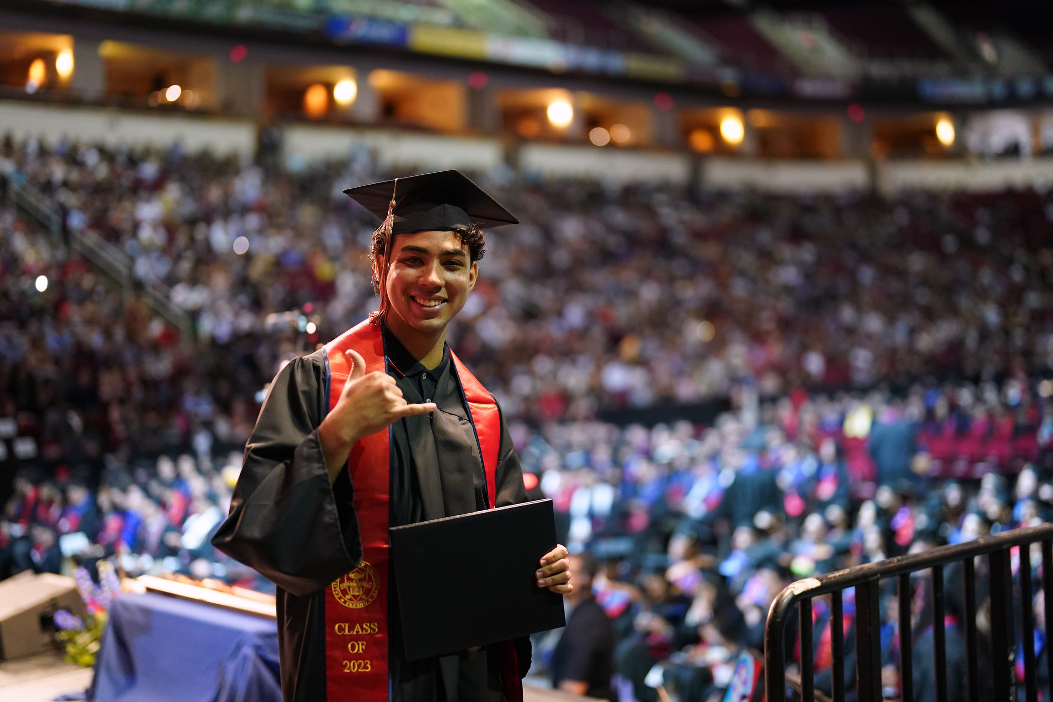 college graduate holding diploma