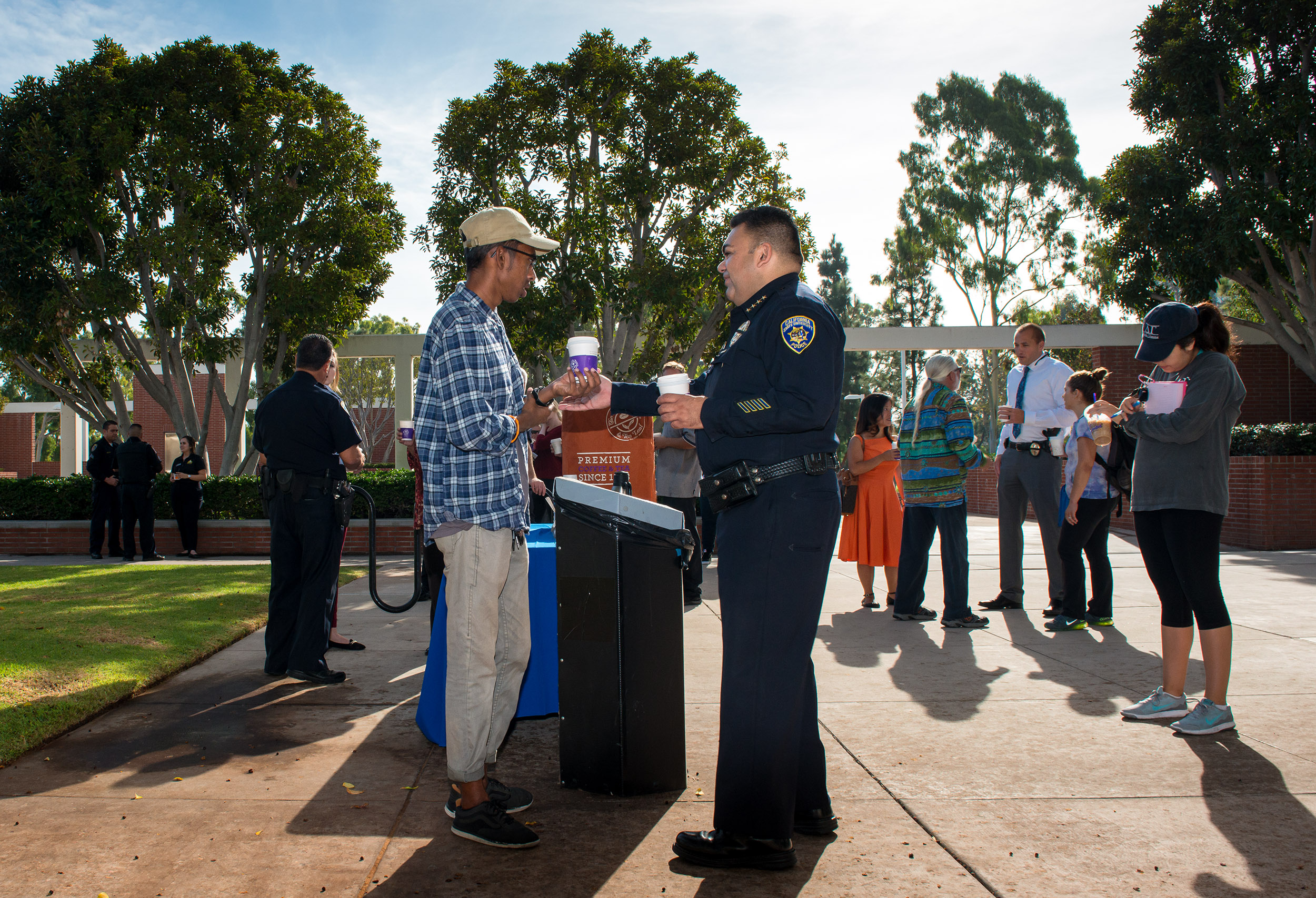 A police officer on a college campus talking a student