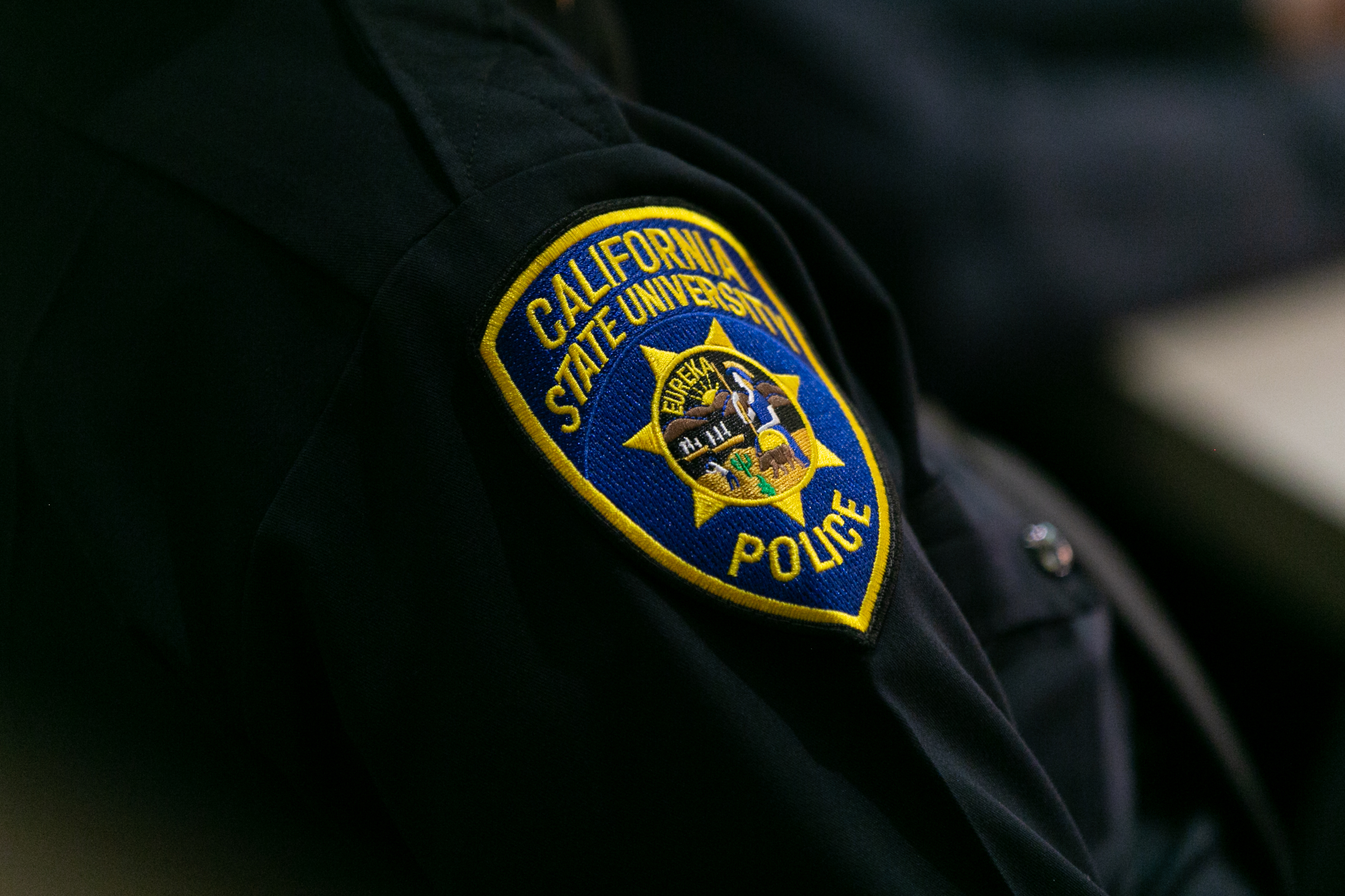 A close up of a C S U police officers patch
