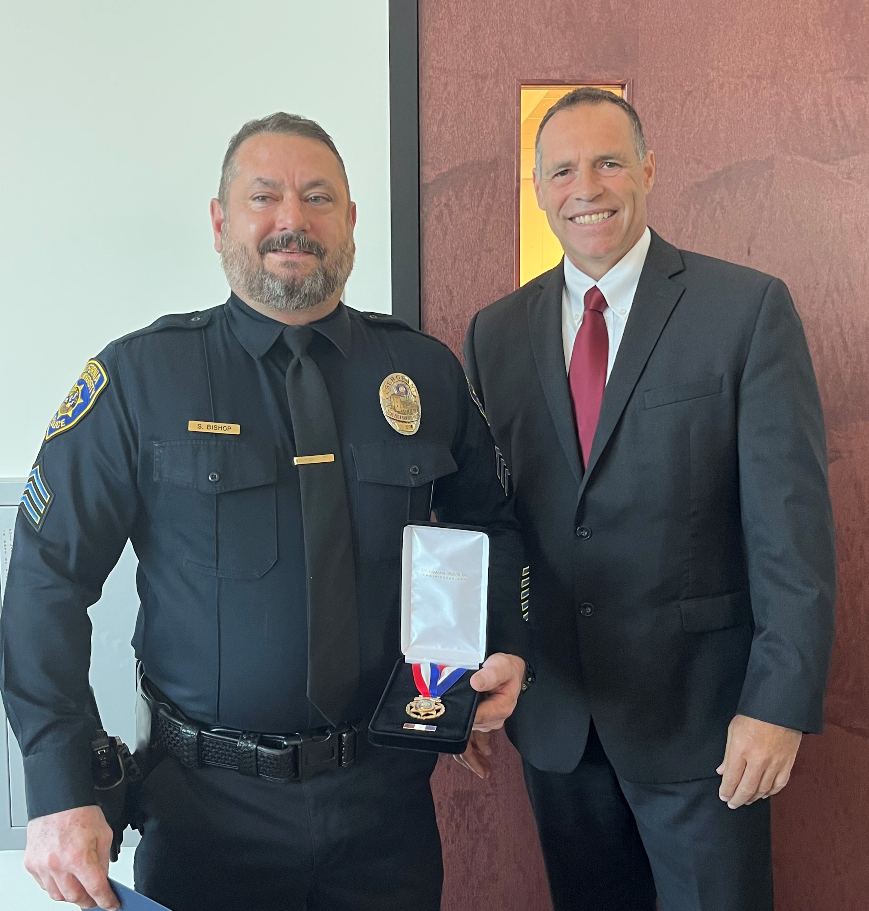 a police officer holding an award