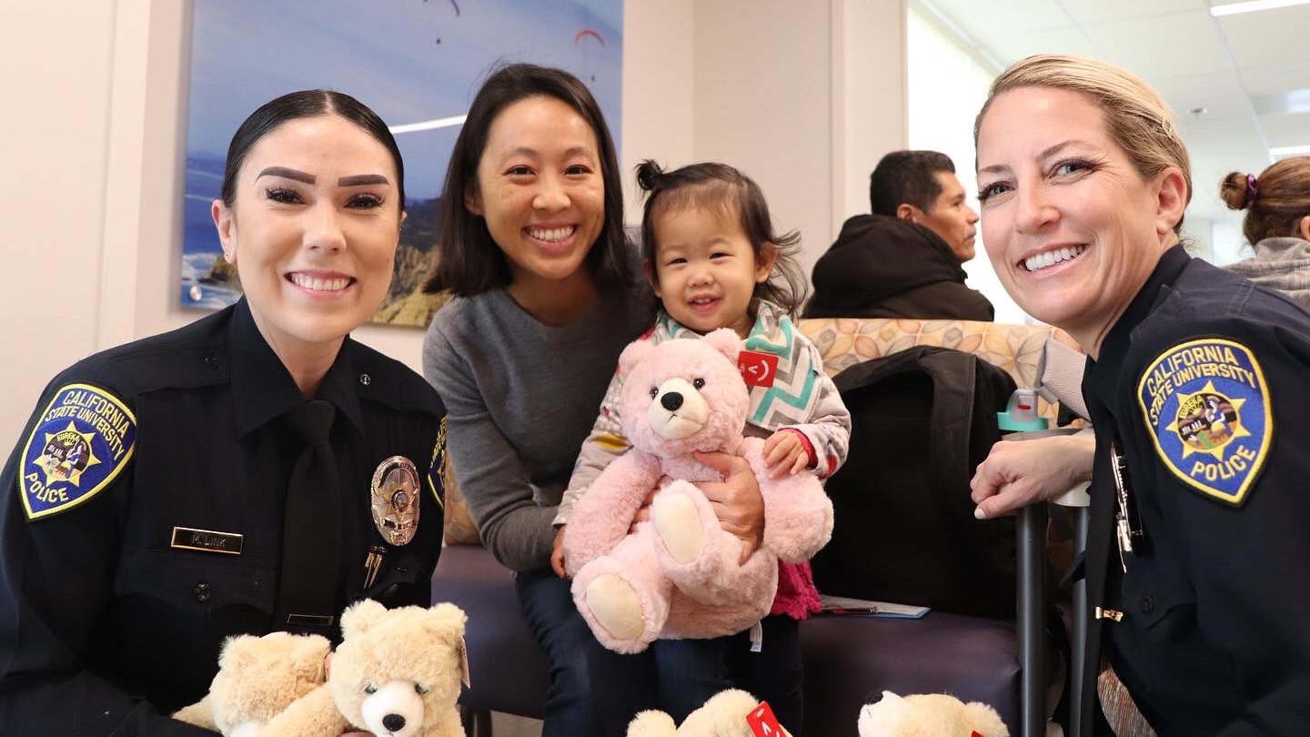 c s u police officers pose with children
