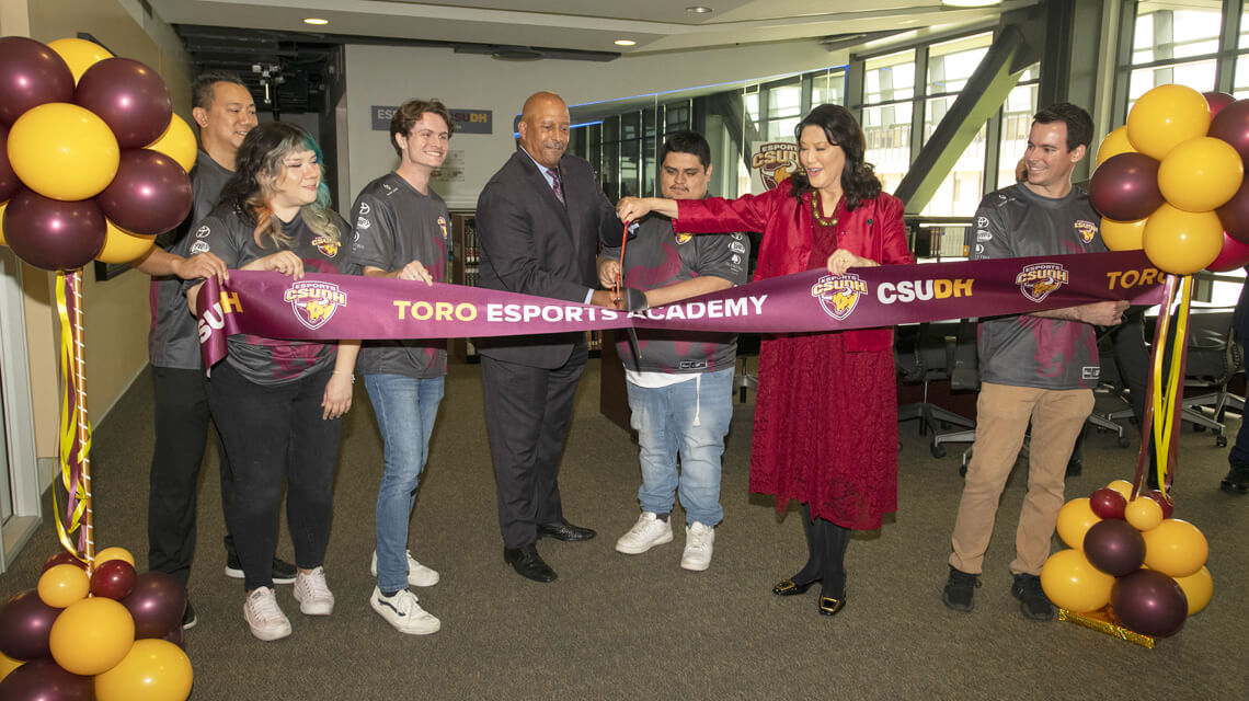 a group of people cutting a ribbon at a building opening