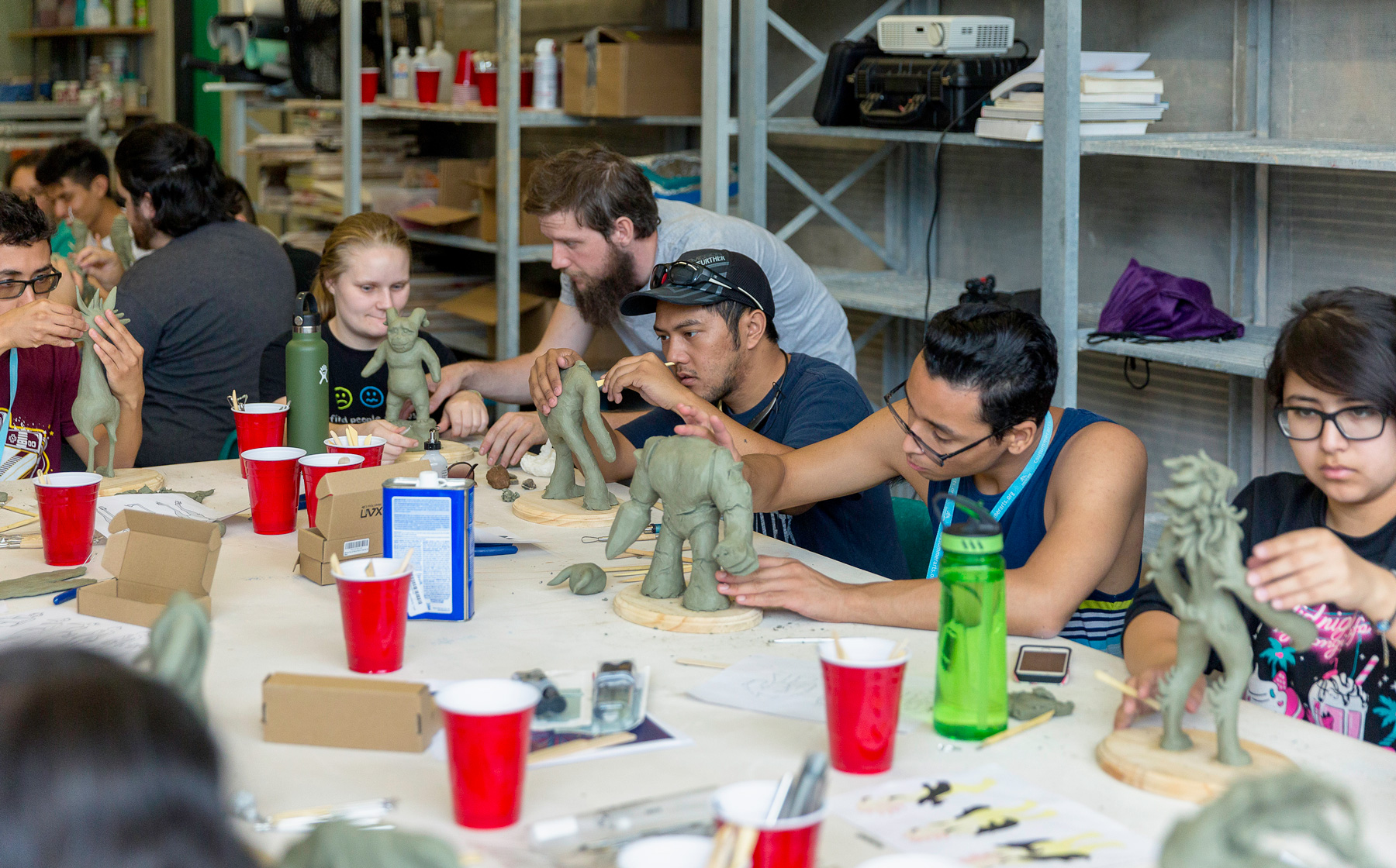 student sculpting figures from clay