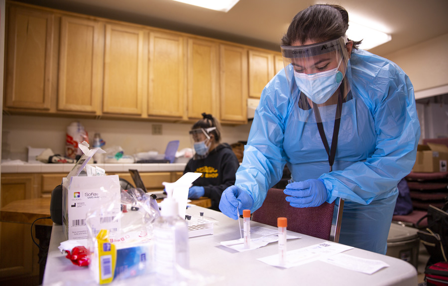 SDSU community health workers process COVID-19 test samples utilizing the Quidel Sofia 2 analyzer.