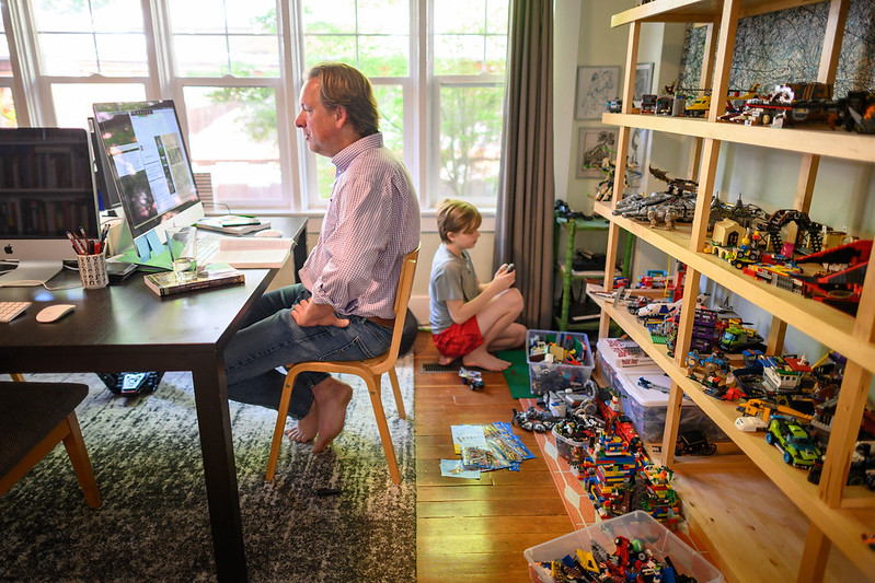 instructor working from homw with child in background