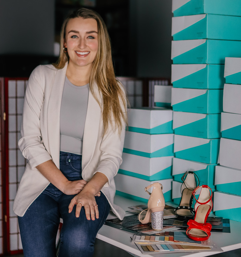 Haley Pavone poses next to her products.