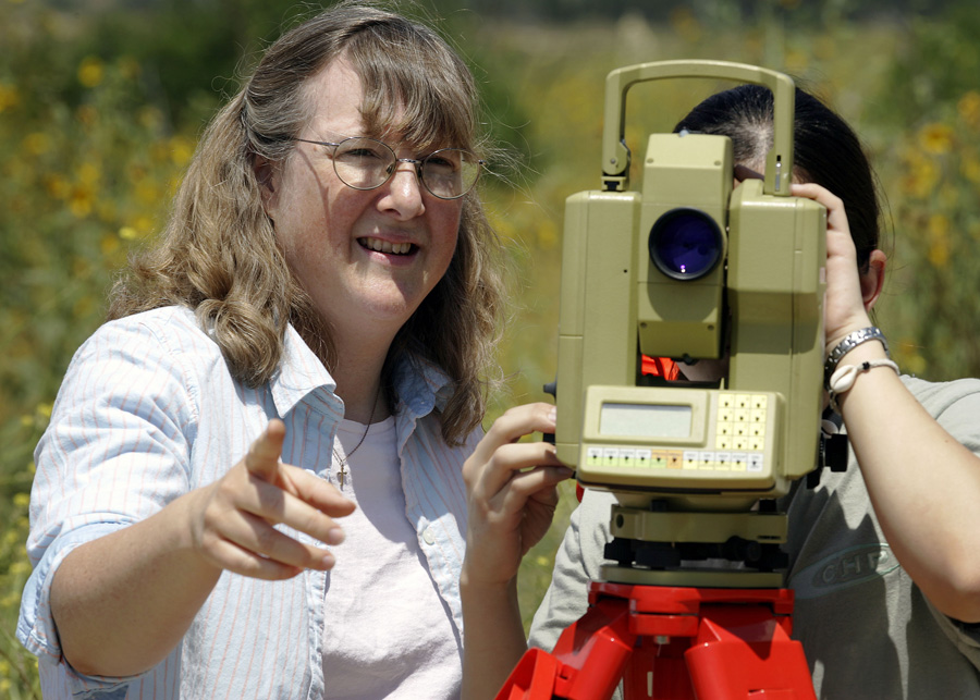 Dr. Sally McGill working with a student in the field.