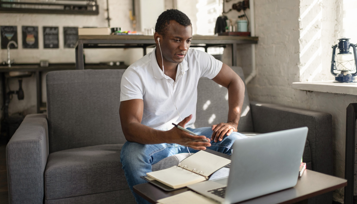 man sitting on couch while video conferencing