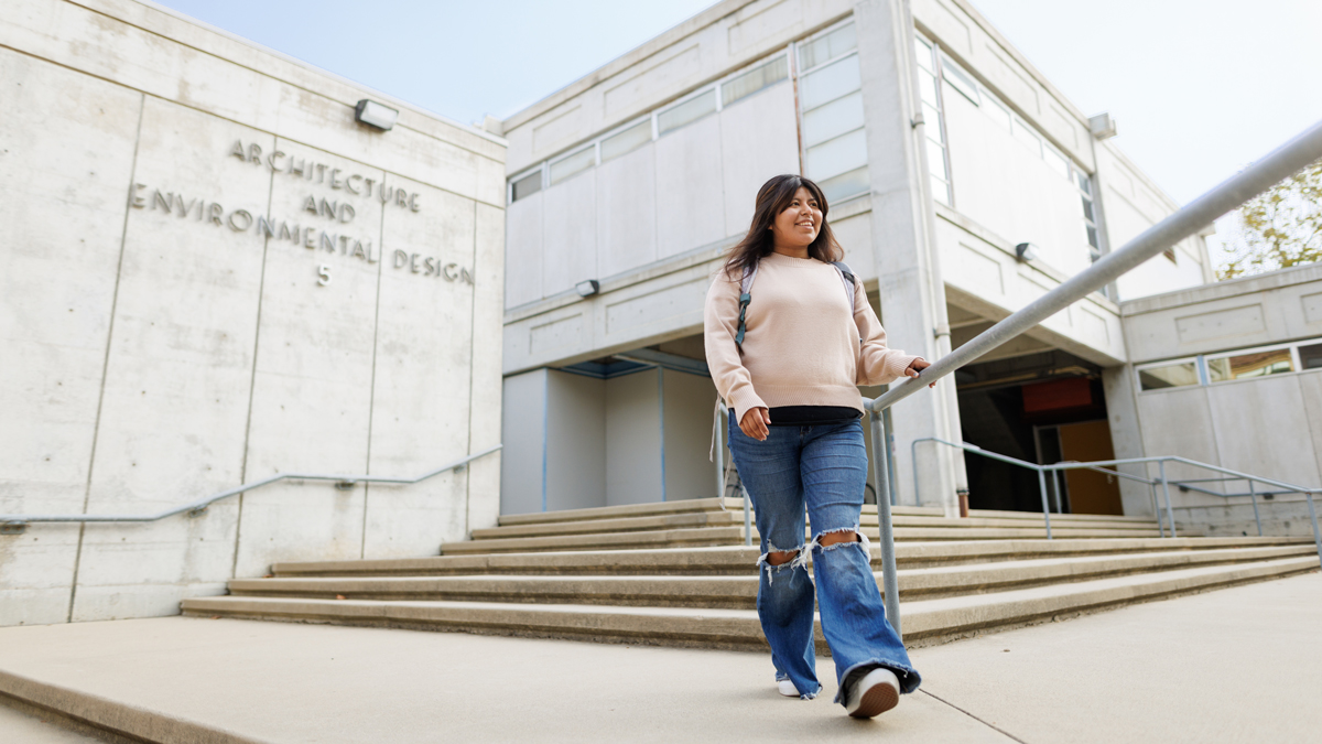 Odalys Martinez walks outside the Architecture and Environmental Design building at Cal Poly.