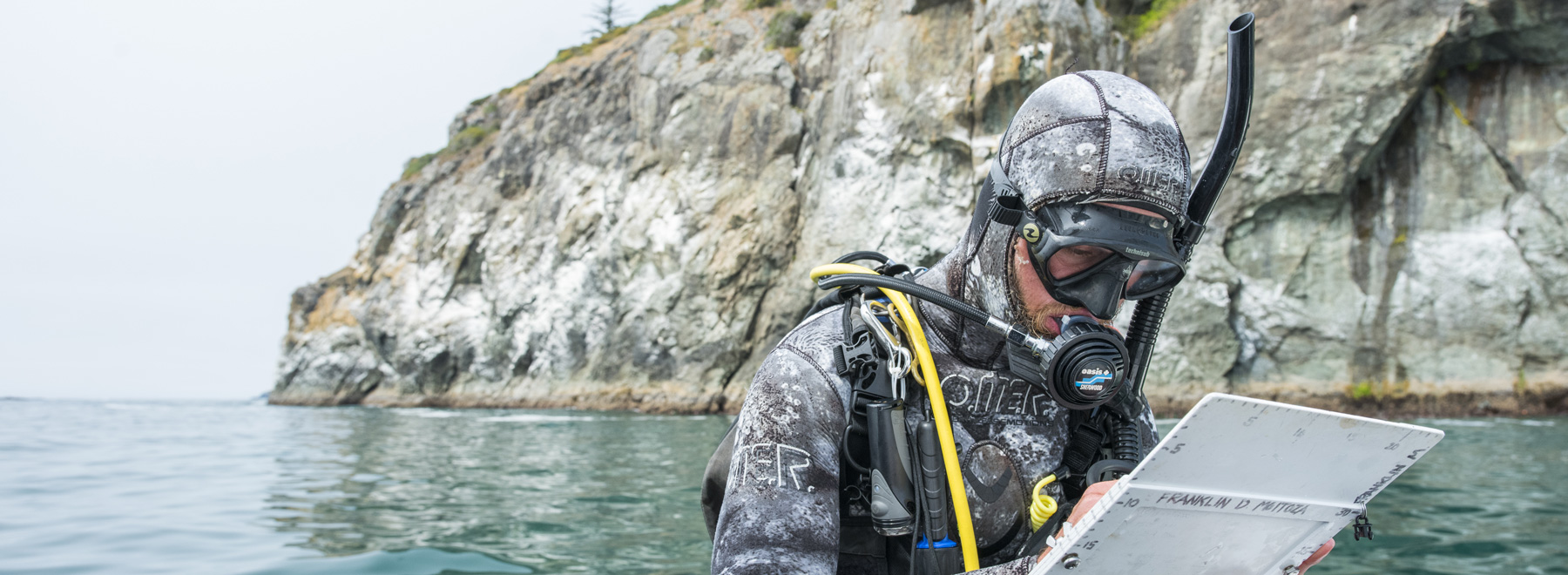 Diver writes notes while floating in the ocean