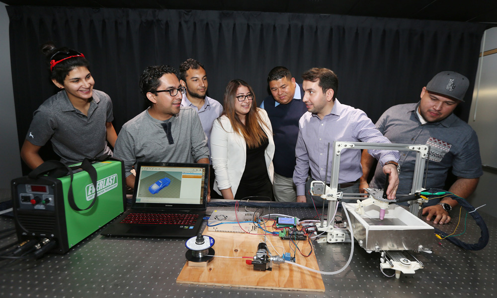 Dr. Mohsen Eshraghi demonstrating a 3D printer to students
