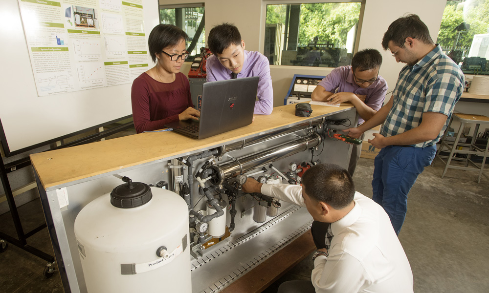 Dr. Reza Baghaei Lakeh, and Dr. Ali Sharbat, work with water treatment equipment
