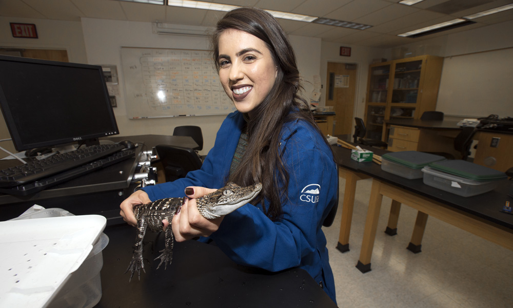 photo of Janelle Doyle holding an aligator