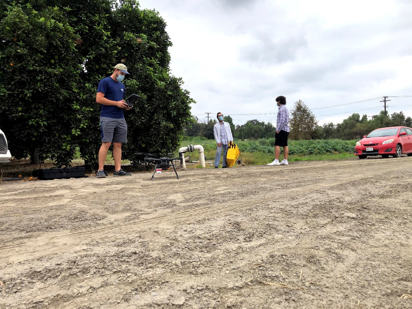 Vikram Sai Kishan takes a picture of his teammates laying out ground control points and setting up the drone.